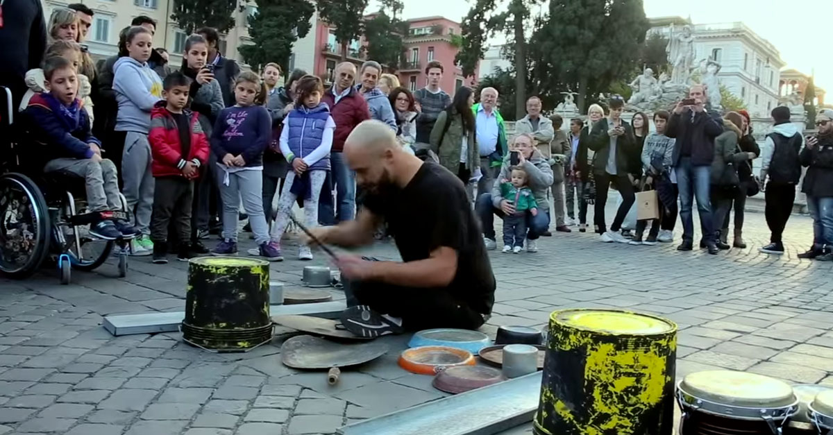 This street performer makes beautiful music out of pieces of junk