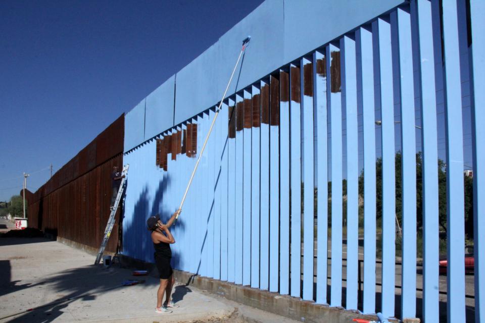 Why an artist painted a U.S.-Mexico border fence sky blue